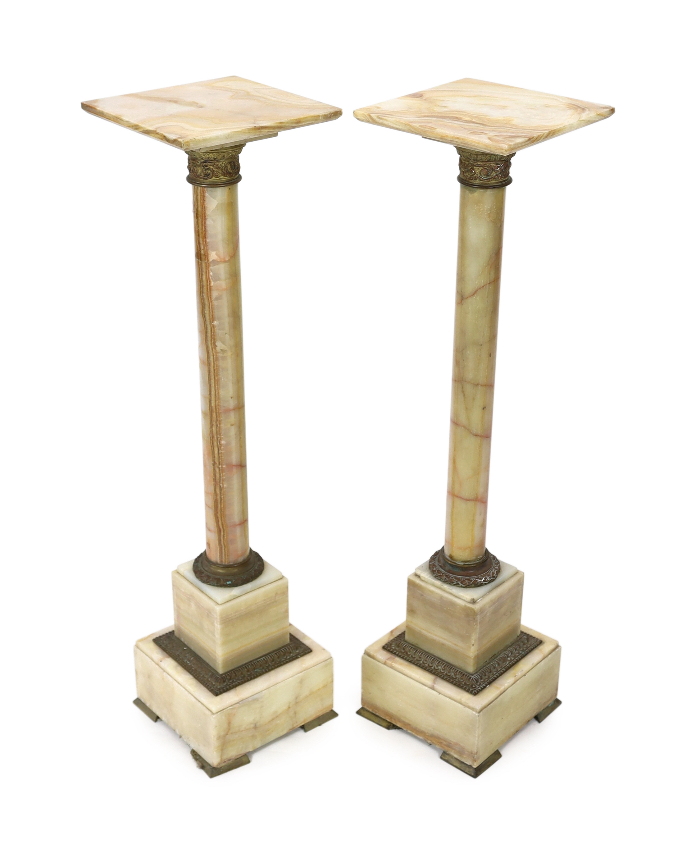 A pair of early 20th century French ormolu mounted onyx pedestals, width 25cm, height 99cm